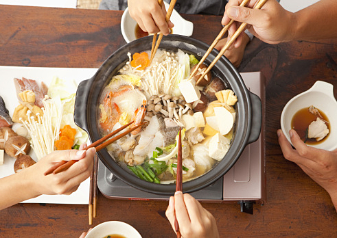 Parents and children eating Japanese nabe