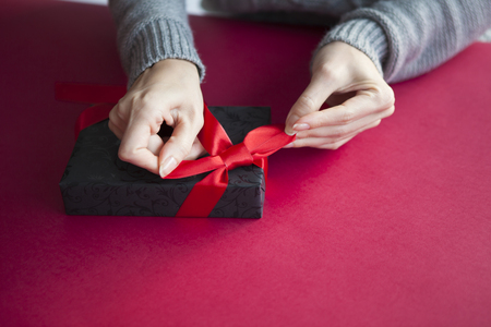 70943749 - a woman wrapping a gift box